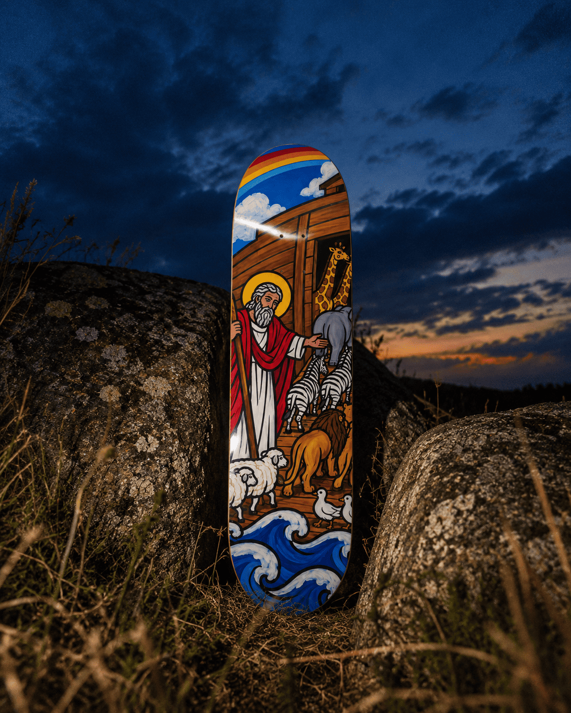 Noah’s Ark skateboard wall art standing upright between two lichen-covered boulders at dusk, sunset glow on the horizon