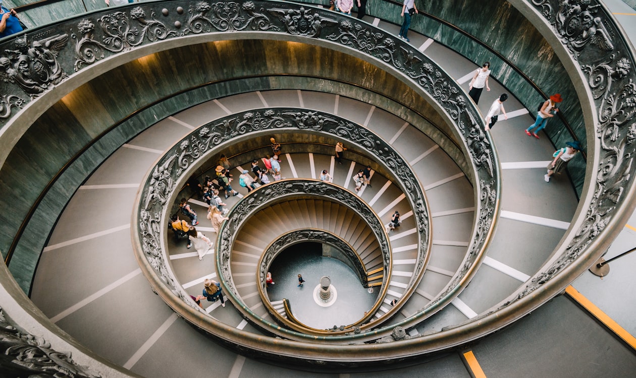 Vatican Museums spiral staircase — the architectural setting where Raphael painted the School of Athens in the Apostolic Palace