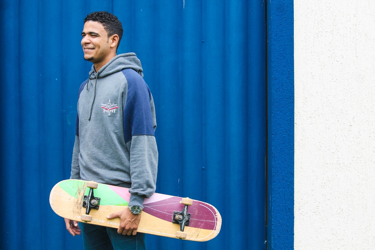 man holding brown and purple skateboard