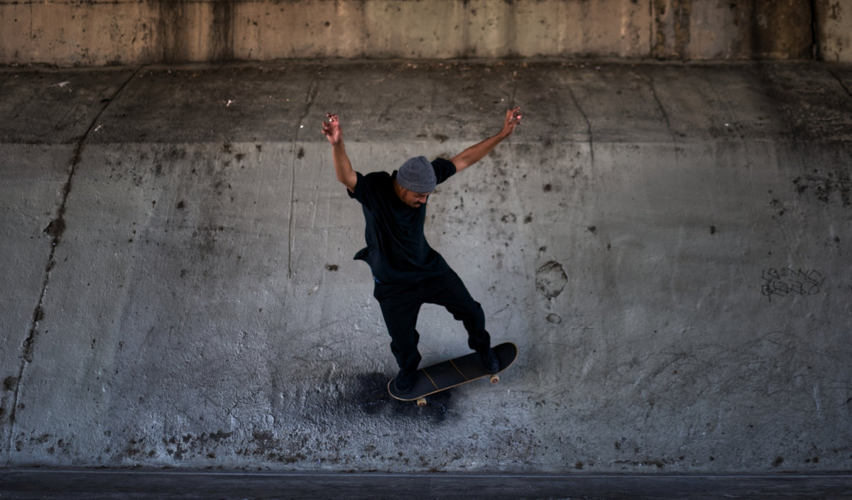 man in black t-shirt and black pants riding skateboard