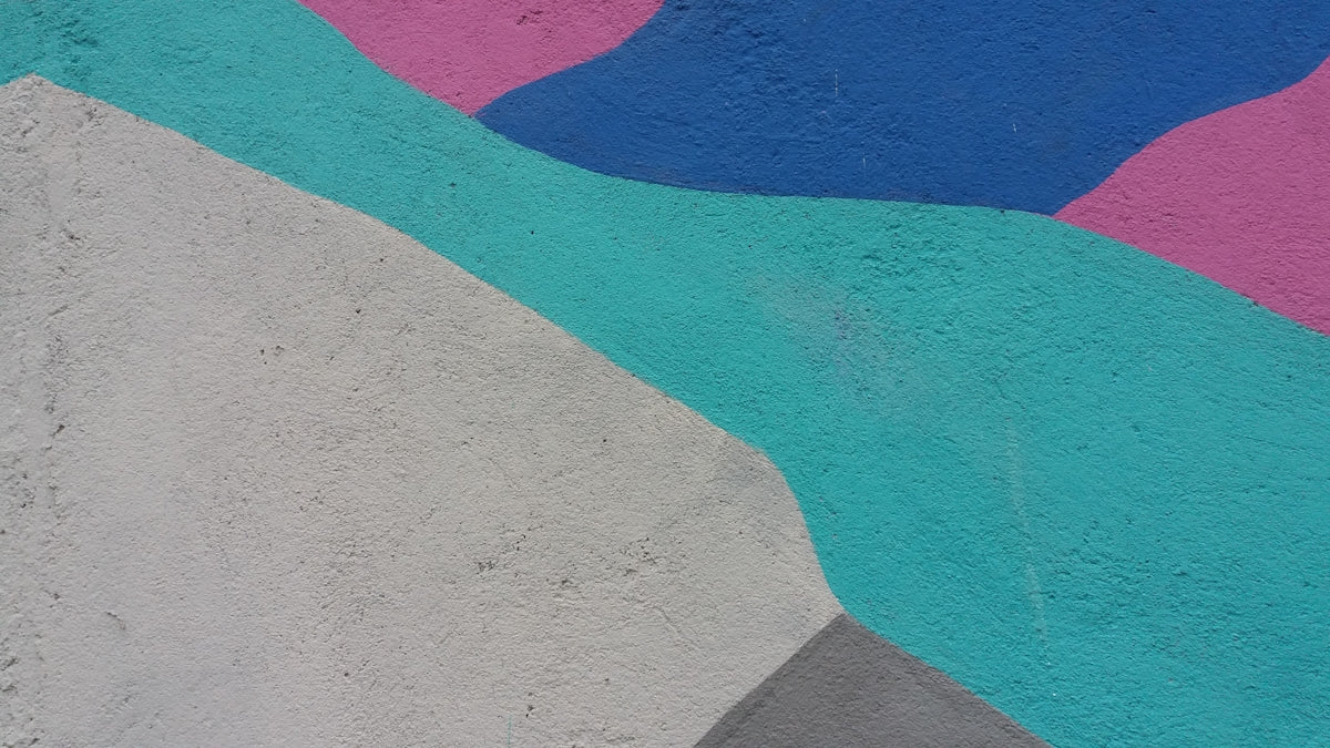a skateboard is leaning against a colorful wall