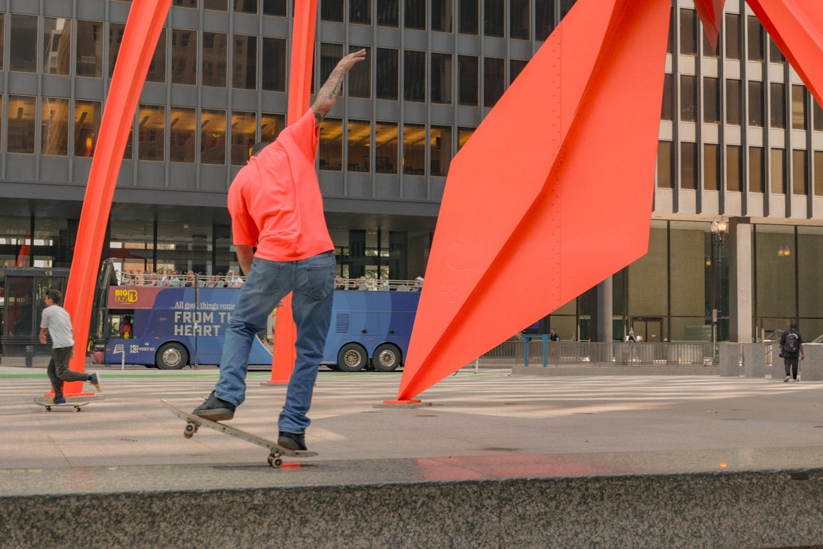 a man riding a skateboard next to a tall building