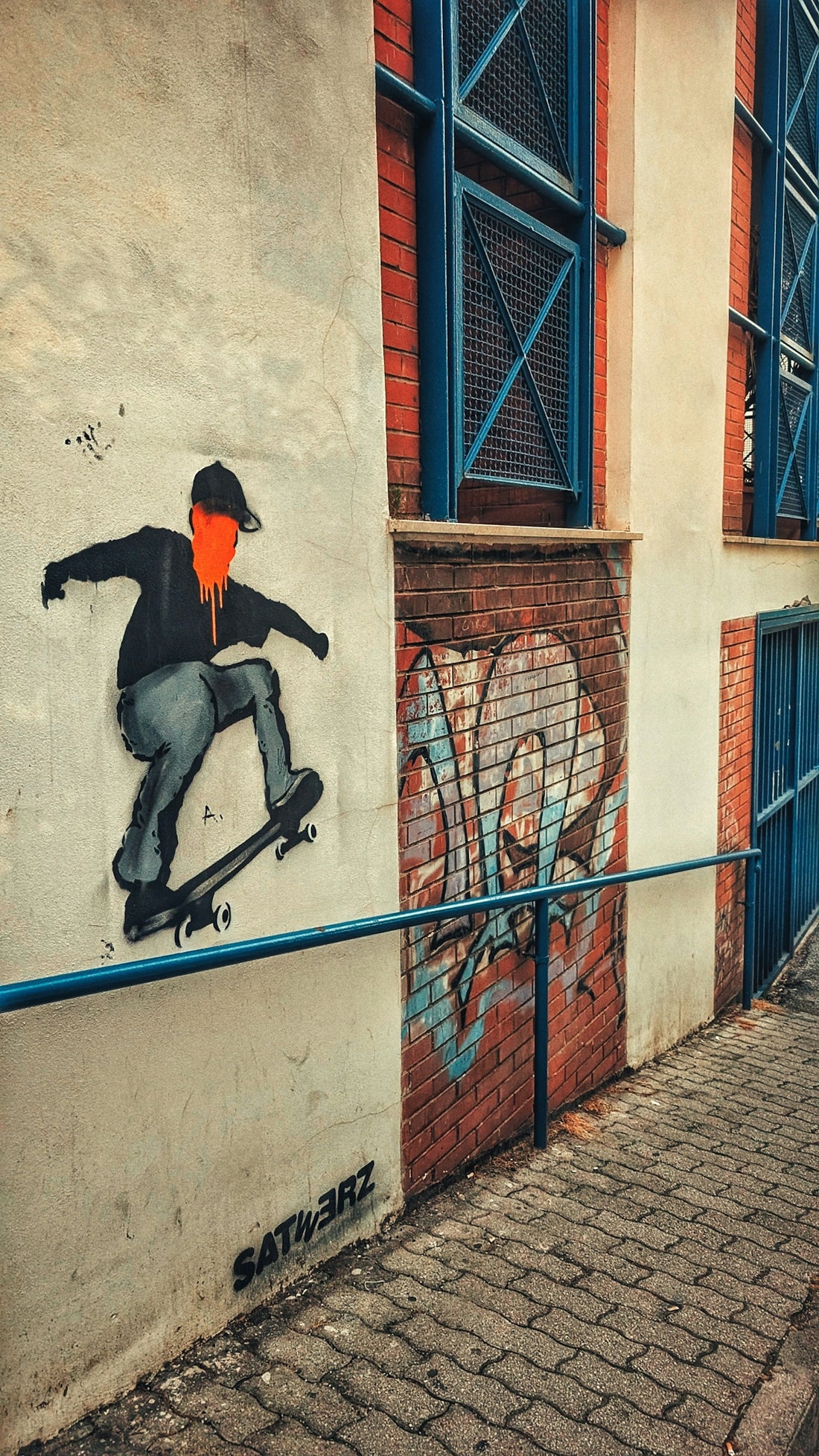 A man riding a skateboard down the side of a building
