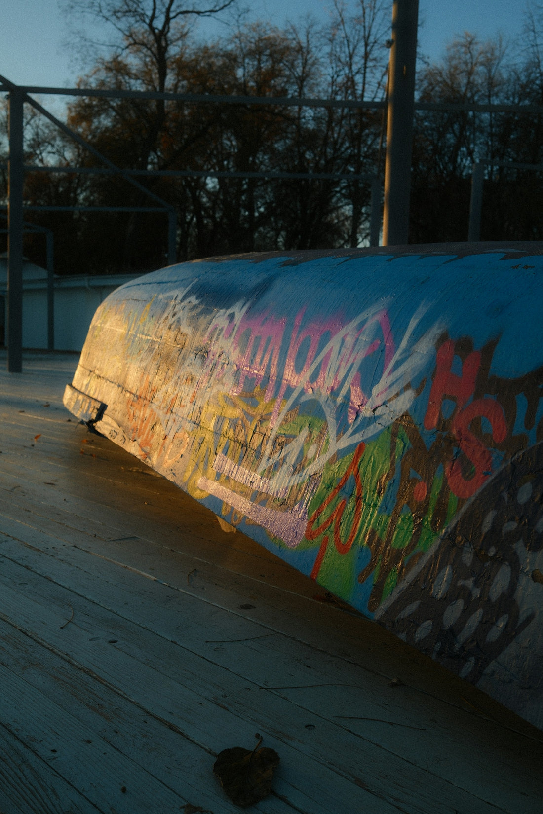 A man riding a skateboard on top of a wooden floor
